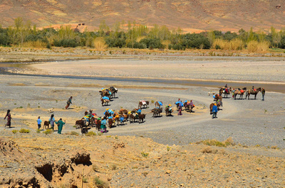 Nomads crossing a dry river bed
