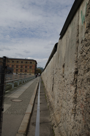 The Berlin Wall was a guarded concrete barrier that physically and ideologically divided Berlin from 1961 to 1989
